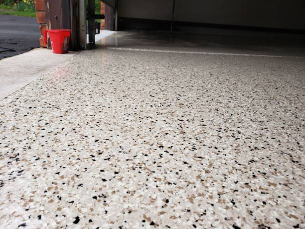 Cream gray flake epoxy garage floor near open garage door